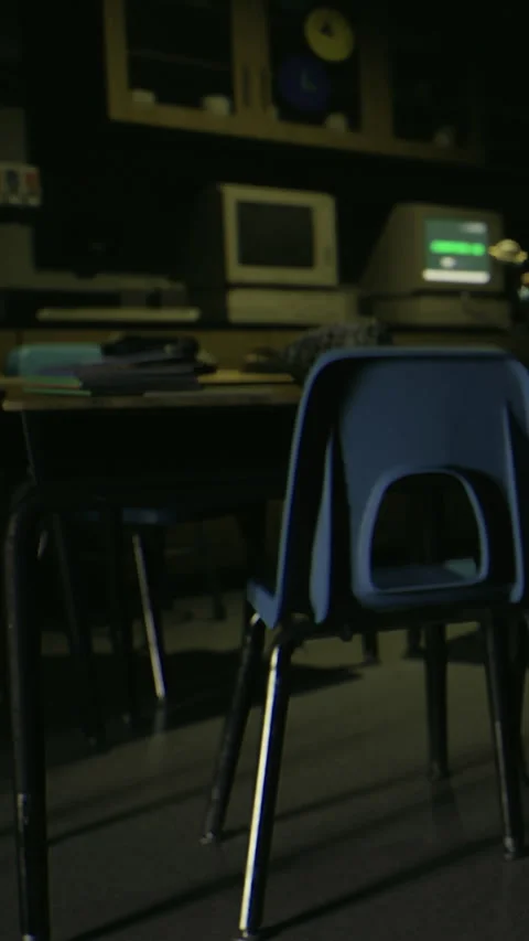 Empty classroom with chairs and old computers in low light settings Stock Footage 332232430