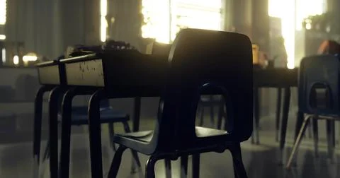 Empty classroom with chairs and tables during golden hour light 스톡 일러스트