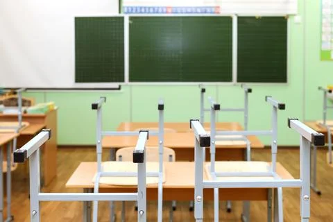 Empty Classroom with Chairs on Desks, Symbolizing the End of the School Year Stock Photos