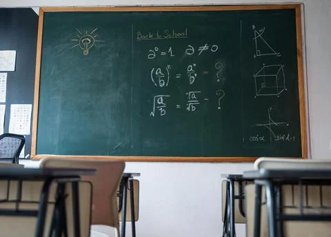 Empty classroom with chairs elementary school desks and chalkboard Stock Photos