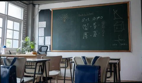 Empty classroom with chairs elementary school desks and chalkboard Stock Photos