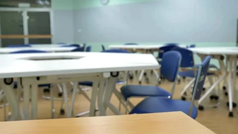 Empty classroom with chalkboard and rows of desks with chairs. Break at schoo Stock Footage 256720542