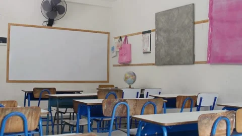 Empty classroom with chalkboard and rows of desks with chairs. Break at schoo Stock Footage 256720691