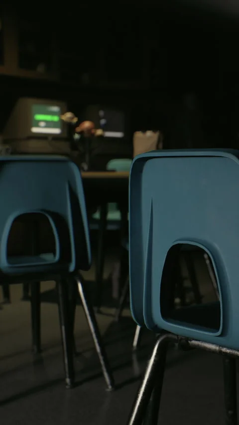 Empty classroom contains green chairs and a table with a computer screen Stock Footage 341988221