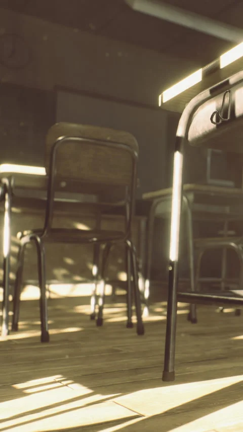 Empty classroom with desks and chairs lit by sunlight in the afternoon Stock Footage 334248092