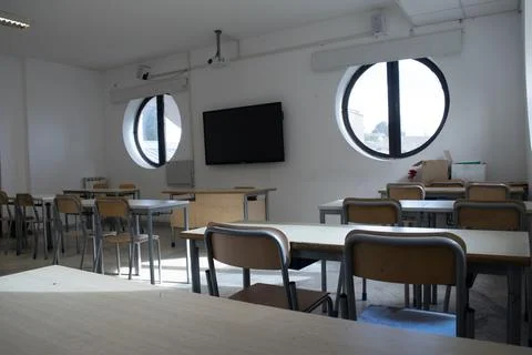 Empty classroom with desks and chairs Stock Photos