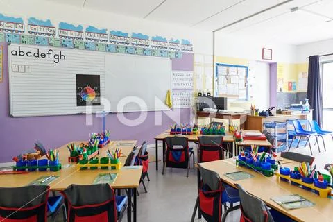 Empty Classroom In Elementary School With Whiteboard And Desks Stock Photos