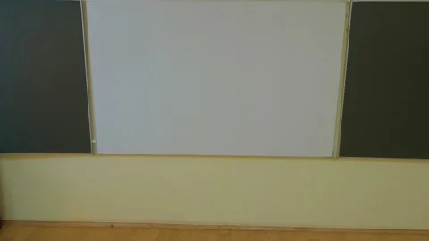 An empty classroom is equipped with desks and a whiteboard, ready for an Video stock 277933022