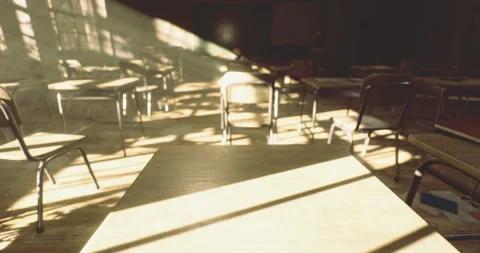 Empty classroom filled with warm sunlight during the late afternoon hours Stock Footage 324713493