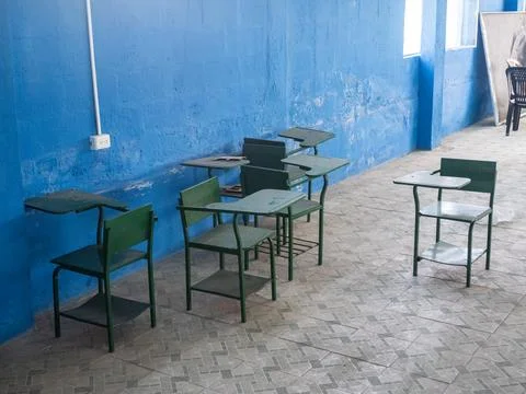 Empty classroom with green tables and chairs Stock Photos