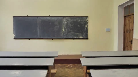 Empty Classroom With Grey School Desks And Simple Black Blackboard Stock Footage 139611200