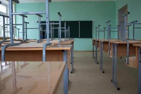 Empty classroom, inverted chairs on desks, distance learning during the pande Stock Photos