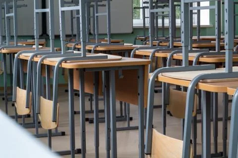 Empty classroom, inverted chairs on desks, distance learning during the pande Stock Photos