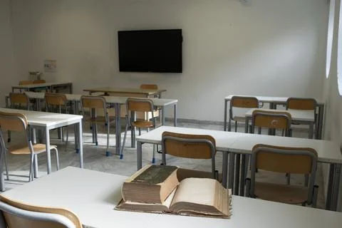 Empty classroom with modern desks and television Stock Photos