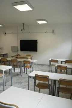 Empty classroom with modern desks and television Stock Photos
