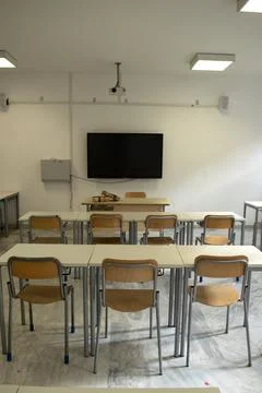 Empty classroom with modern desks and television Stock Photos