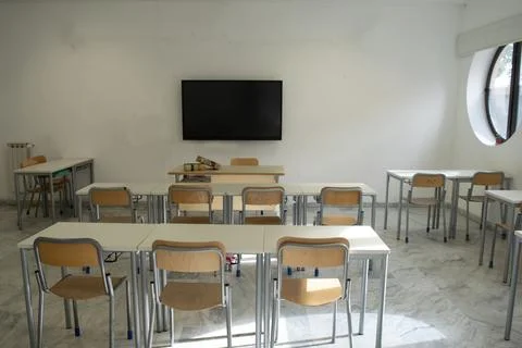 Empty classroom with modern desks and television Stock Photos
