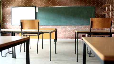 Empty classroom with neat desks, big chalkboard and chairs. Back to School Stock Footage 256720325
