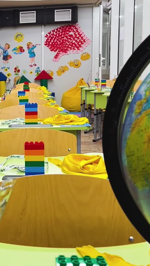 An empty classroom at school with desks and a globe on the teachers desk Stock Footage 311974501