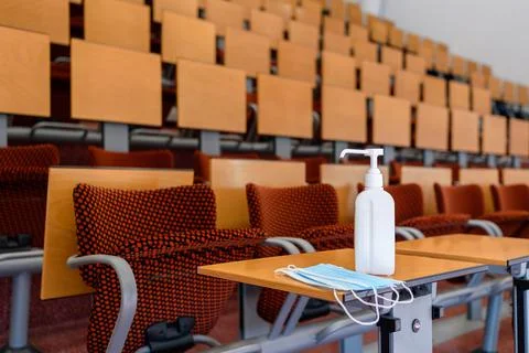 Empty classroom with set of face masks and sanitizer Stock Photos