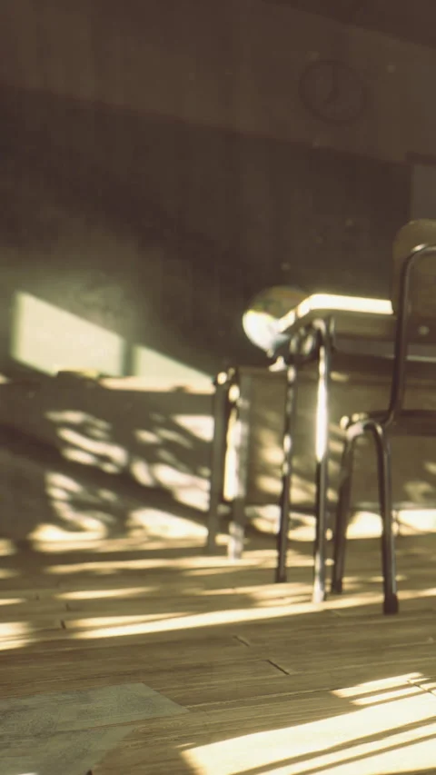 Empty classroom with sunlight and shadows on the floor and desk in afternoon Stock Footage 335236842
