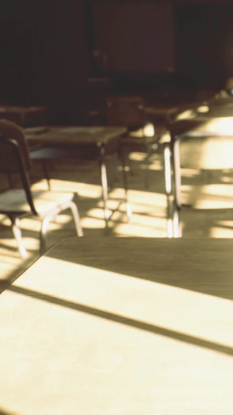 Empty classroom with sunlight shining through windows in afternoon Stock Footage 334248094