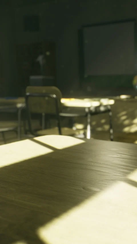 Empty classroom with sunlight shining on a wooden table and chairs Stock Footage 334723956