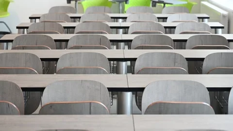 Empty classroom in University. Lecture room. Chairs and tables in class Stock Footage 310026192