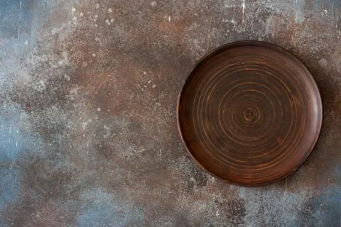 Empty clay  plate on stone  background Stock Photos