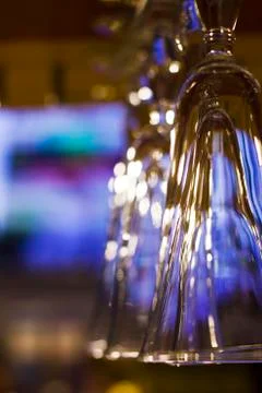 The empty clean glasses in bar, upside down, close up Stock Photos