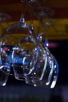 The empty clean glasses in bar, upside down, close up Stock Photos
