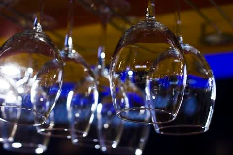 The empty clean glasses in bar, upside down, close up Stock Photos