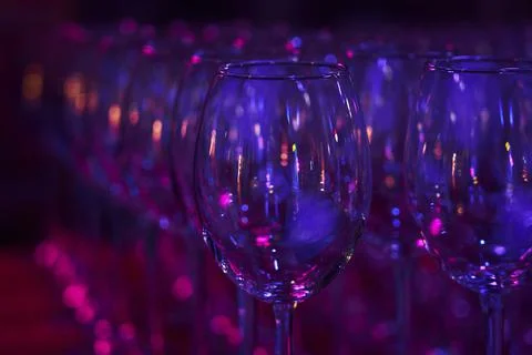 Empty clean glasses in several rows in neon light Stock Photos
