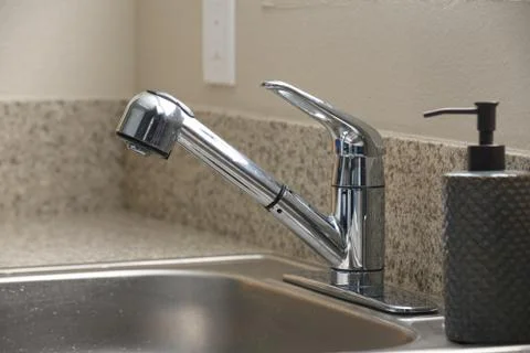 Empty clean kitchen sink and soap dispenser Stock Photos