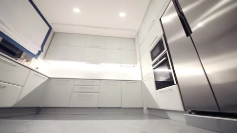 Empty clean white kitchen with built-in appliances in apartment Stock Footage 276364438