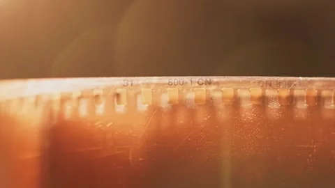 Empty clear damaged 35 mm film photography strip slo mo 4k Stock Footage 340585384