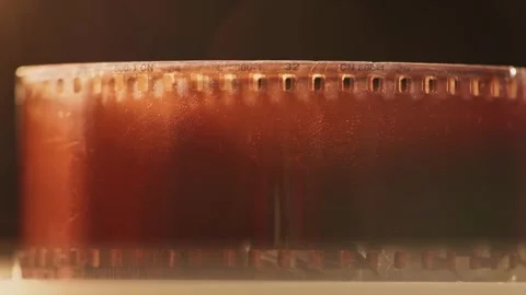 Empty clear damaged 35 mm film photography strip slo mo 4k Stock Footage 340586392