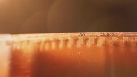 Empty clear damaged 35 mm film photography strip slo mo 4k Stock Footage 340586408