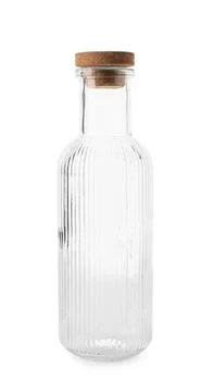 Empty clear glass bottle with ribbed texture and cork stopper for beverages a Stock Photos