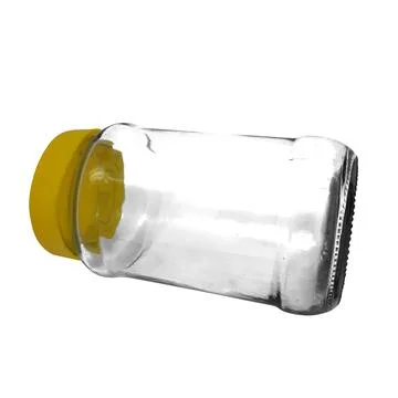 Empty clear glass jar with bright yellow screw cap perfect for kitchen pant.. Stock Photos