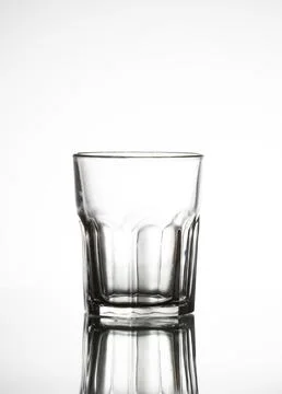 Empty clear glass showing reflection on white background Stock Photos