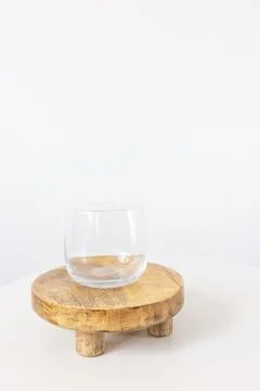 Empty clear small juice or water glass on tray, white background Foto stock