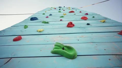 Empty climbing wall in a climbing center adventure park with colorful grips Stock Footage 308657667