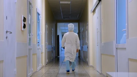 Empty clinic corridor with doctor passing by. Private clinic, hospital, medical Stock Footage 104888280