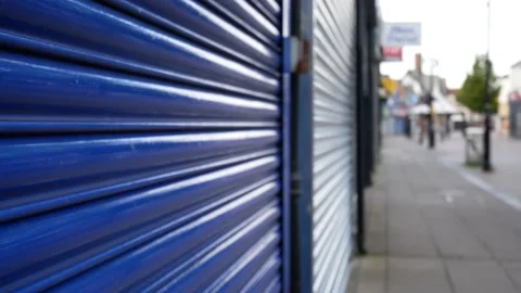 Empty closed corona virus small town retail shop security blue shutter in 動画素材 136241747