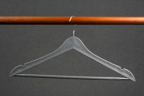 Empty clothes hanger hanging on a green background. Accessories and items for Stock Photos