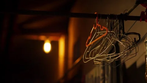 Empty Clothes Hangers in Dark Room Stock Footage 344235770