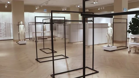 Empty clothing store. Empty counters, hangers and mannequins. Stock Footage 220450315