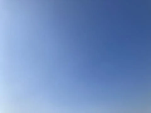 Empty cloudless sky ranging in color from white to bright blue 写真素材