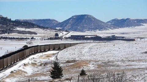 Empty coal train pushers curve across the shot and out Stock Footage 105190947